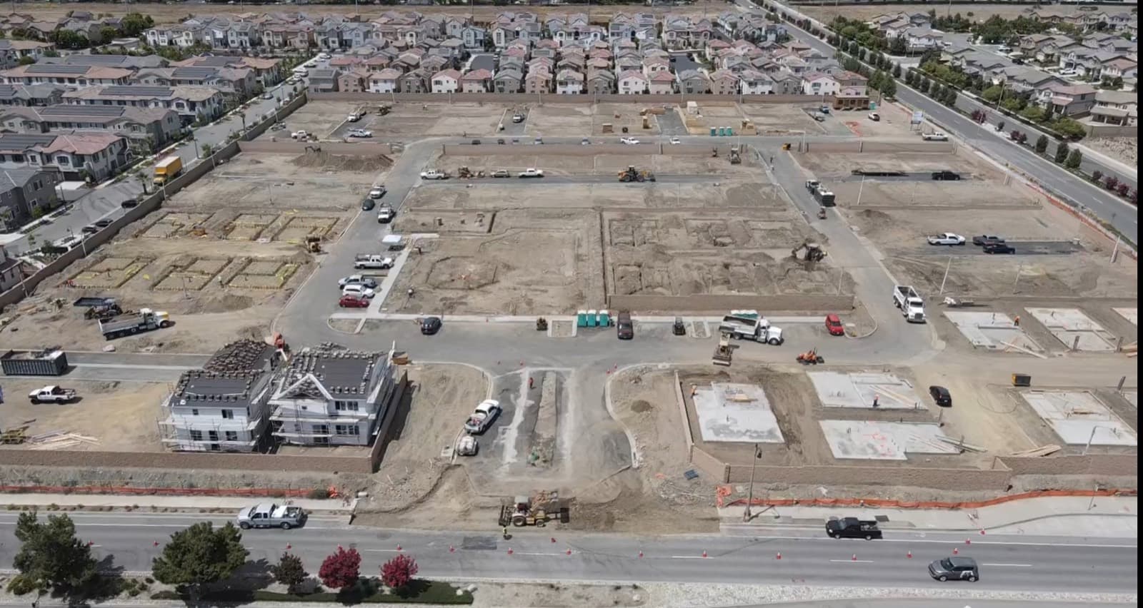 Citrus Summit residential tract with streets, pads, and homes under construction